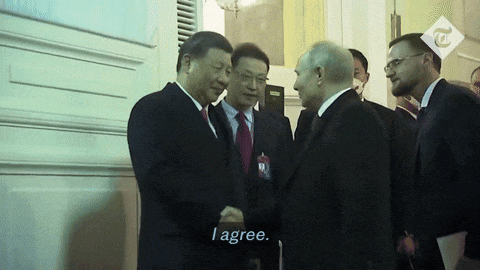 a man in a suit shakes hands with another man in a suit and tie with the caption i agree
