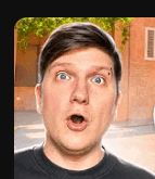a close up of a man 's face with his mouth open and a brick building in the background .