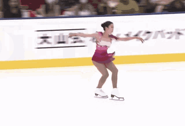 a woman is ice skating in front of a lotto sign