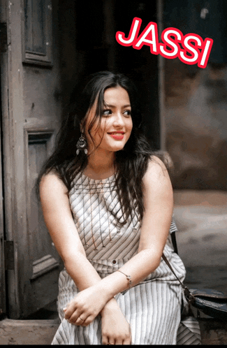 a woman sitting in front of a door with the name jassi on the bottom