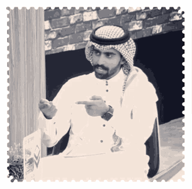a black and white photo of a man in a traditional arabic dress