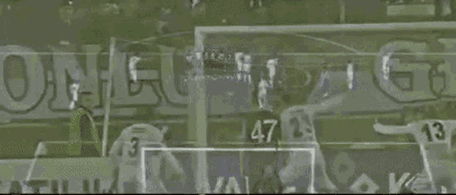 a soccer game is being played and the number 47 is on the back of a player 's jersey