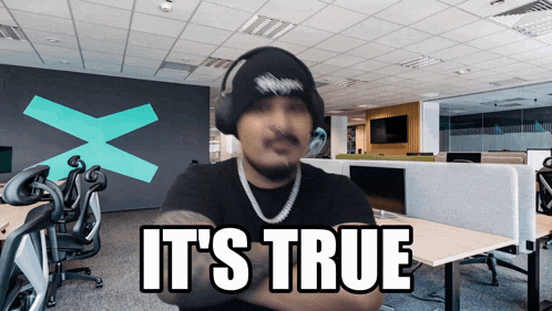 a man wearing headphones says " it 's true " in an office