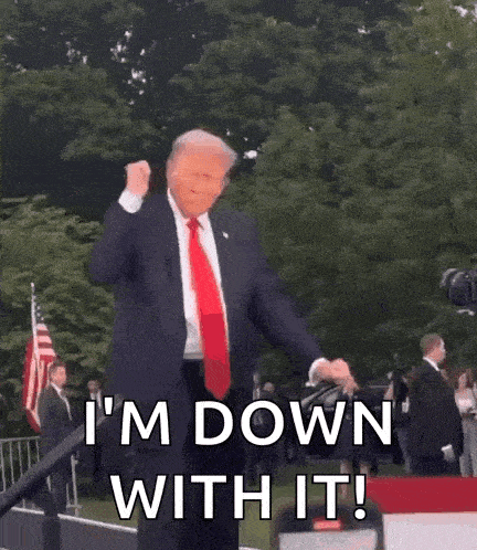a man in a suit and tie is dancing in front of a crowd and says `` i 'm down with it '' .