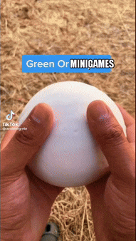 a person is holding a white ball in their hands with the words green or minigames above it