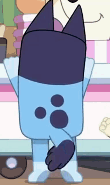 a cartoon character is standing in front of a pink and white striped table with his arms outstretched .