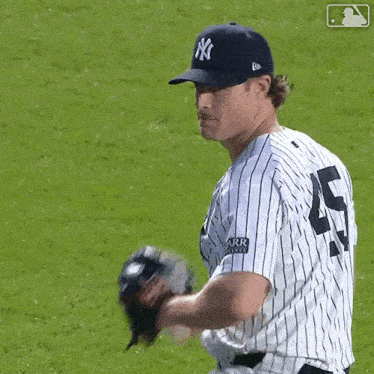 a new york yankees baseball player wearing a number 5 jersey throws a baseball