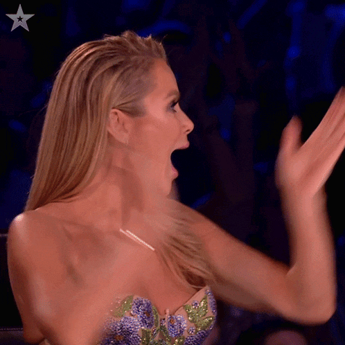 a woman applauds with a star in the corner