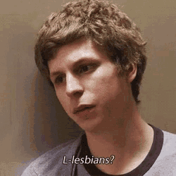 a close up of a man 's face with the words `` l-lesbians '' written on the bottom .