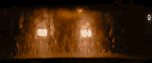 a blurry picture of a car 's headlights on a rainy night