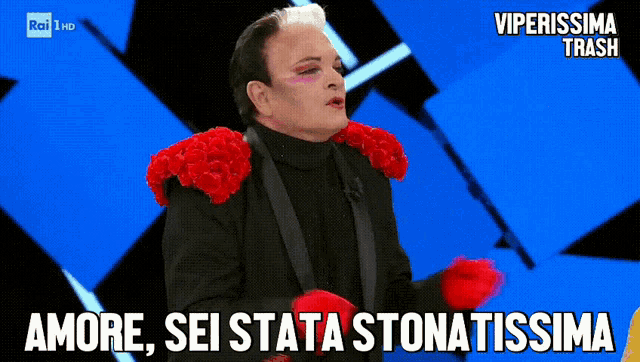a man with red flowers on his shoulders says amore