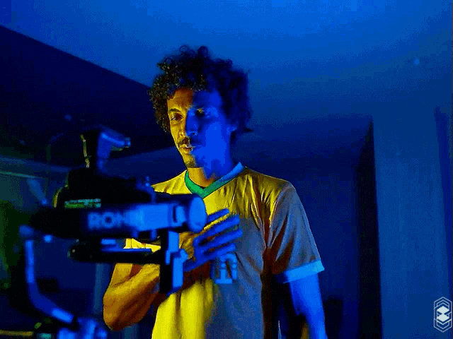 a man wearing a yellow shirt that says shurfah