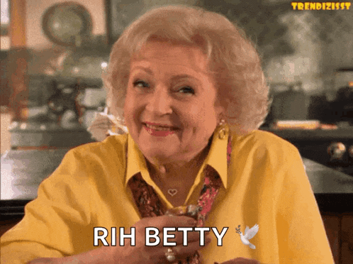 an elderly woman in a yellow shirt is smiling and says rih betty