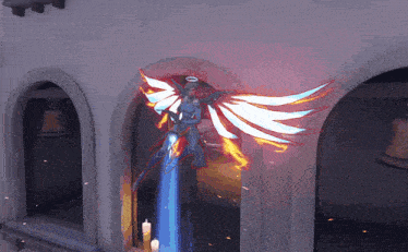 a statue of a woman with angel wings is in front of a door
