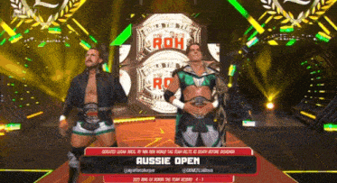 two wrestlers on a stage with the words aussie open
