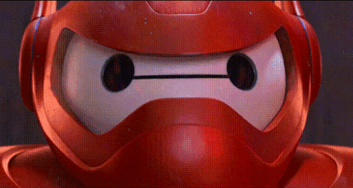 a close up of a red robot 's face with a helmet on .