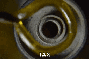 a close up of a metal object with the word tax written on it