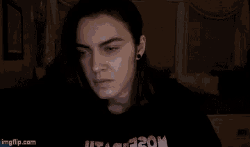 a woman with long hair is holding a pen in her hand .