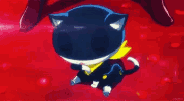a black and white cat with a yellow scarf on is sitting on a red surface .