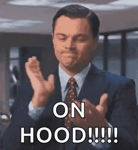 a man in a suit and tie is clapping his hands and saying on hood