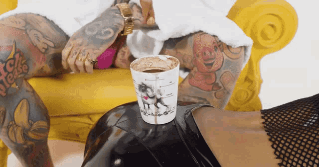 a cup of coffee with a unicorn on it sits on a woman 's bottom