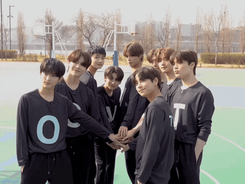 a group of young men are posing for a picture and one of their shirts says o on it