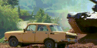 a yellow car is parked in the dirt next to a large tank .