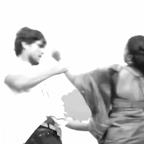 a man and a woman are dancing in a black and white photo
