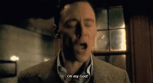 a man in a suit is screaming with his eyes closed and says `` oh my god '' .