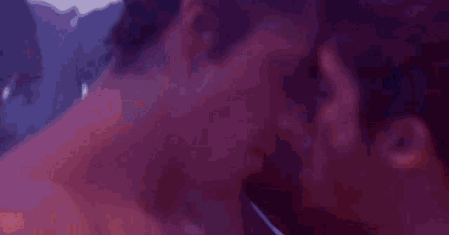 a close up of two men kissing each other in a room .