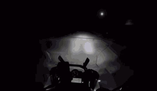 a dark room with a light coming out of the corner