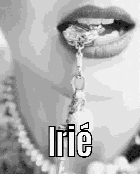 a close up of a woman 's mouth with a necklace hanging from it .