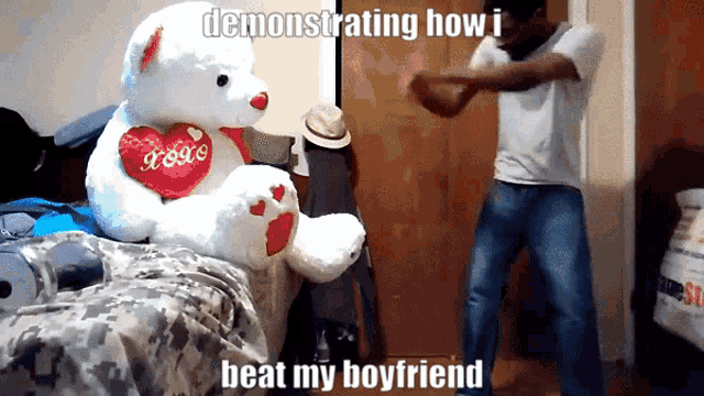 a white teddy bear with a red heart that says je t'aime