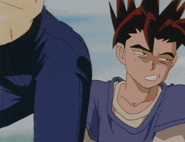 a man in a blue shirt is standing next to another man with red hair
