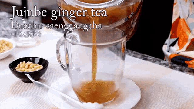 jujube ginger tea is being poured into a cup
