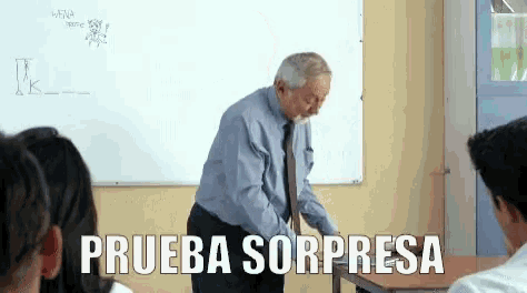 a man stands in front of a whiteboard with the words prueba sorpresa written on it