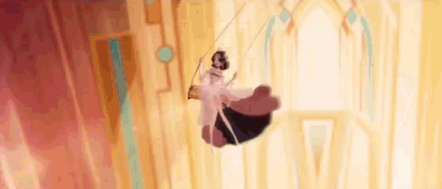 a woman in a white dress is flying through the air on a trapeze .