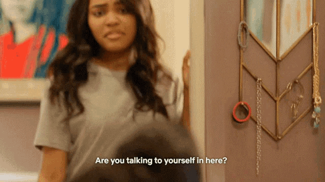 a woman is talking to herself in the mirror