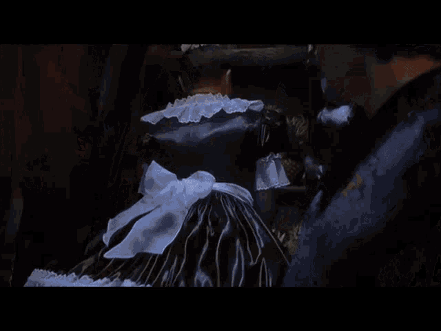 a group of people standing in a dark room with smoke coming out of the ceiling
