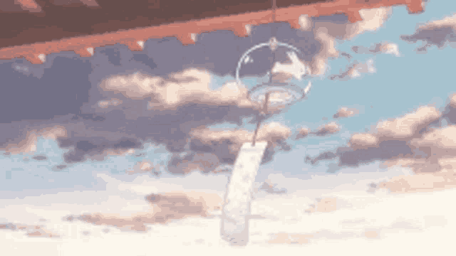 a wind chime is hanging from the roof of a building in the sky .