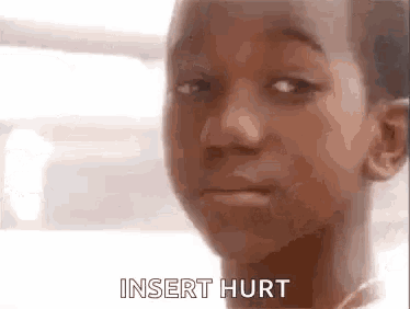 a close up of a young boy 's face with the words `` insert hurt '' written on the bottom .