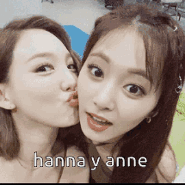 two women are kissing each other with the words hanna y anne written on the bottom