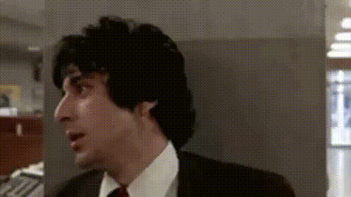 a man in a suit and tie is looking to his left