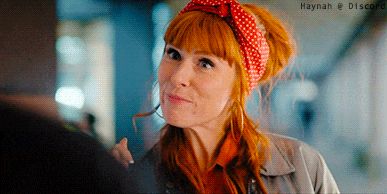 a woman with red hair wearing a red and white polka dot headband with haynah @ discord written below her