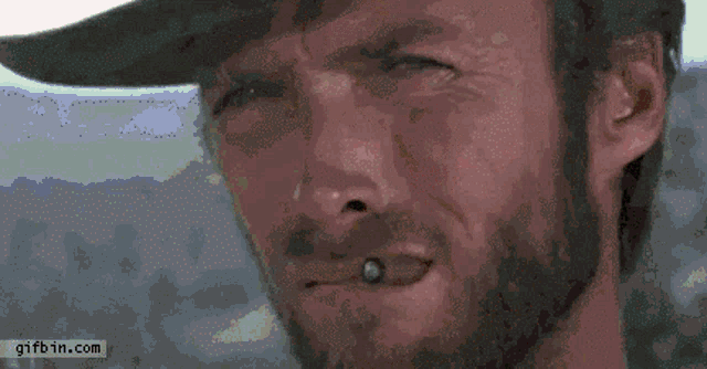a close up of a man 's face with a gifbin.com watermark at the bottom