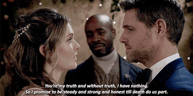 a bride and groom are looking at each other while a man stands behind them
