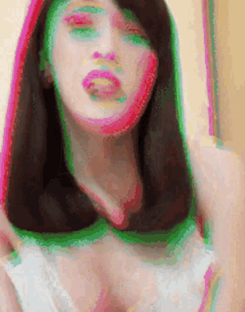 a blurry picture of a woman 's face with green and pink lines