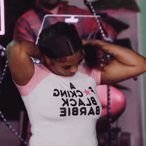a woman wearing a t-shirt that says barbie