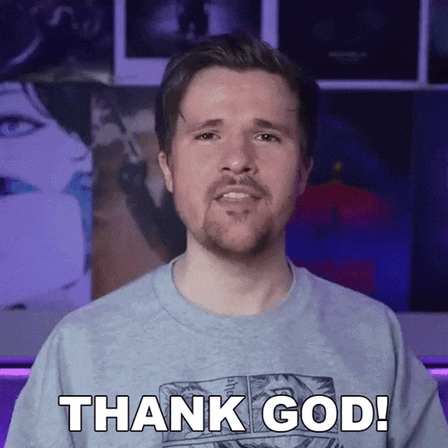 a man with a beard is wearing a gray shirt that says thank god