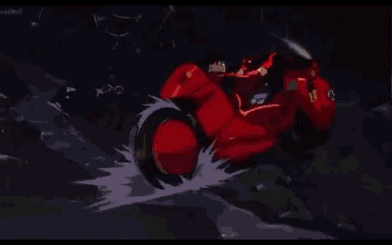 a close up of a red motorcycle with a green light coming out of the tire .